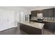 Modern kitchen featuring stainless steel appliances, granite countertops, and center island with sink at 7099 Skippingstone Way, Douglasville, GA 30134