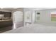 Open-concept living room with carpet, view of kitchen and natural light at 7099 Skippingstone Way, Douglasville, GA 30134