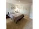 Neutral bedroom featuring a comfortable bed with decorative pillows and accent chair at 776 Woodstock Grove Dr, Woodstock, GA 30188