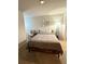 Neutral bedroom featuring a comfortable bed with decorative pillows and accent chair at 776 Woodstock Grove Dr, Woodstock, GA 30188