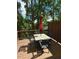 Wooden deck area with table, chairs, umbrella and a view of the surrounding foliage at 776 Woodstock Grove Dr, Woodstock, GA 30188