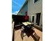 Wooden deck area with outdoor table, chairs, and umbrella near the side of the house at 776 Woodstock Grove Dr, Woodstock, GA 30188