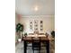 Dining room with modern light fixture, table with seating for six, and picture frames at 776 Woodstock Grove Dr, Woodstock, GA 30188