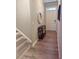 Inviting entryway with wood-look flooring, console table, and stairs leading to the upper level at 776 Woodstock Grove Dr, Woodstock, GA 30188