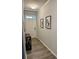Bright entryway with wood-look flooring, artwork, and a console table at 776 Woodstock Grove Dr, Woodstock, GA 30188