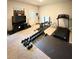 Spacious home gym featuring weights, treadmill, and weight bench for exercise at 776 Woodstock Grove Dr, Woodstock, GA 30188