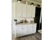 Kitchen featuring white cabinets, granite countertops, modern hardware, and decorative backsplash at 776 Woodstock Grove Dr, Woodstock, GA 30188