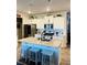 Open kitchen with white cabinets, a granite island with seating, and stainless steel appliances at 776 Woodstock Grove Dr, Woodstock, GA 30188