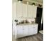 Kitchenette with white cabinets, granite countertops, and white brick backsplash at 776 Woodstock Grove Dr, Woodstock, GA 30188
