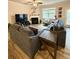 Cozy living room featuring a fireplace, large sectional sofa, and natural light at 776 Woodstock Grove Dr, Woodstock, GA 30188