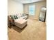 Well lit living room featuring a couch, carpet, throw pillows, and mirror at 776 Woodstock Grove Dr, Woodstock, GA 30188