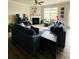 Spacious living room featuring large windows, a fireplace, neutral decor, and comfortable seating at 776 Woodstock Grove Dr, Woodstock, GA 30188