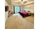 Spacious bedroom featuring a large window, ceiling fan, plush carpet, and comfortable furniture at 776 Woodstock Grove Dr, Woodstock, GA 30188