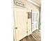A view of the pantry door with pantry signage and wooden floors at 776 Woodstock Grove Dr, Woodstock, GA 30188