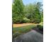 A grassy yard with large mature trees, a perfect outdoor space for a quiet time at 803 Arbor Gate Ln, Lawrenceville, GA 30044