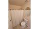 Cozy bathroom featuring a shower, toilet, and oval mirror at 803 Arbor Gate Ln, Lawrenceville, GA 30044