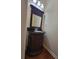 Bathroom with ornate wood vanity, black countertop, and decorative mirror at 803 Arbor Gate Ln, Lawrenceville, GA 30044