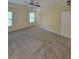 Large primary bedroom with a ceiling fan, carpeted floor, and lots of windows at 803 Arbor Gate Ln, Lawrenceville, GA 30044
