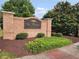 Community entrance sign 'The Arbors at Sugarloaf' with landscaped garden area at 803 Arbor Gate Ln, Lawrenceville, GA 30044