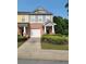 Charming townhome with colorful siding, brick accents, and a convenient one-car garage at 803 Arbor Gate Ln, Lawrenceville, GA 30044