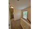 Bright hallway featuring one window and neutral carpeting at 803 Arbor Gate Ln, Lawrenceville, GA 30044