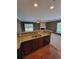 Kitchen pass-through into the living room with granite counters, wood cabinets, and stainless steel sink at 803 Arbor Gate Ln, Lawrenceville, GA 30044