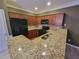 Well-lit kitchen featuring granite countertops, wood cabinets, and modern appliances at 803 Arbor Gate Ln, Lawrenceville, GA 30044
