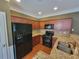 Bright kitchen with granite counters, wood cabinetry, stainless steel sink, and modern appliances at 803 Arbor Gate Ln, Lawrenceville, GA 30044