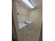 Efficient laundry room featuring a washer, dryer, and shelving at 803 Arbor Gate Ln, Lawrenceville, GA 30044