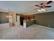 Open-concept living area with carpet, a ceiling fan, and a clear view to dining and kitchen at 803 Arbor Gate Ln, Lawrenceville, GA 30044