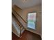Carpeted staircase with white railing and a natural wood handrail leads upstairs at 803 Arbor Gate Ln, Lawrenceville, GA 30044