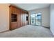Bedroom features custom wood wardrobe and sliding glass doors to balcony with city views at 1280 W Peachtree Nw St # 3514, Atlanta, GA 30309