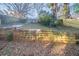 A terraced backyard with a wooden retaining wall provides space and visual appeal at 1453 Graham Sw St, Atlanta, GA 30310