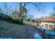 Landscaped backyard view featuring a tall palm tree, wood fence and well maintained grass at 1453 Graham Sw St, Atlanta, GA 30310