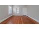 Sunlit bedroom with hardwood floors, neutral paint, and built-in shelving at 1453 Graham Sw St, Atlanta, GA 30310