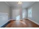 Bright bedroom featuring hardwood floors, neutral paint, and a closet with double doors at 1453 Graham Sw St, Atlanta, GA 30310