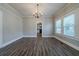 Spacious dining room with luxury vinyl plank flooring and a stylish chandelier at 1453 Graham Sw St, Atlanta, GA 30310