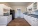 Well-lit kitchen with stainless steel appliances and ample cabinet space, flowing into hall at 1453 Graham Sw St, Atlanta, GA 30310