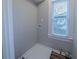 Bright laundry room features wood-look flooring and a window providing natural light at 1453 Graham Sw St, Atlanta, GA 30310