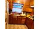 Functional kitchen featuring wood cabinets, vintage appliances, and neutral countertops at 1723 Fort Valley Sw Dr, Atlanta, GA 30311