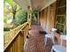 Cozy front porch with a brick floor, wooden railing, and seating at 1723 Fort Valley Sw Dr, Atlanta, GA 30311