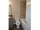Bathroom with tub shower combo, neutral paint, and stylish wood flooring at 3975 Northstrand Dr, Decatur, GA 30035