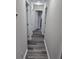 Hallway with modern light fixture, neutral paint, and stylish gray wood flooring at 3975 Northstrand Dr, Decatur, GA 30035