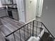 Stylish kitchen view from staircase, with stainless appliances and gray cabinets, adding to the home's appeal at 3975 Northstrand Dr, Decatur, GA 30035