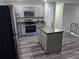 Beautiful kitchen boasts gray cabinets, granite counters, stainless appliances, and a functional island at 3975 Northstrand Dr, Decatur, GA 30035