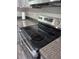 Close-up of new stainless steel range top and granite countertops, adding a luxurious touch to the updated kitchen at 3975 Northstrand Dr, Decatur, GA 30035