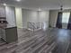 Spacious living area features new floors, neutral paint, staircase, ceiling fan, and lots of natural light at 3975 Northstrand Dr, Decatur, GA 30035