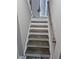 Well-lit stairway with updated hardwood treads, white risers, and neutral walls at 3975 Northstrand Dr, Decatur, GA 30035