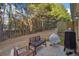 Backyard featuring a grill, patio, and seating, with a wooded area in the background at 426 Mulberry Se Row, Atlanta, GA 30354