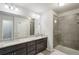 Bathroom featuring double sinks, granite countertops, and glass walk-in shower at 426 Mulberry Se Row, Atlanta, GA 30354